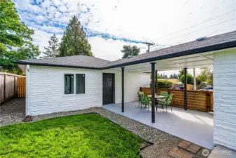 Covered patio area leading to garage door