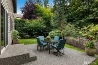 “Sliding door opens to a private backyard with patio and lawn, backed by 6.8 acres of protected greenbelt for lasting privacy.”