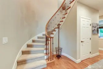 “Statement spiral staircase with wrought-iron banister leads to a bright, sky-lit landing and the home’s thoughtfully designed upstairs layout.”