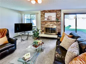 Opposite the bedroom wings sits the wonderful family room with wood burning fireplace and slider access to the back patio and fenced rear yard.