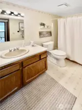 Guest bath with tub/shower combo.