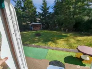 Looking out the trailer door to the private fire pit and wood storage.