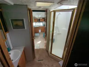 5th wheel bathroom with shower, toilet and sink as well as closet space.