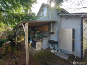 Back of the bunkhouse with covered area for your supplies