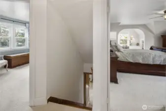 top of stairs, view of two bedrooms