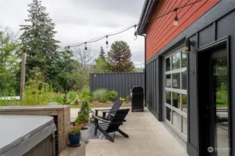View of back patio with storage container in side yard