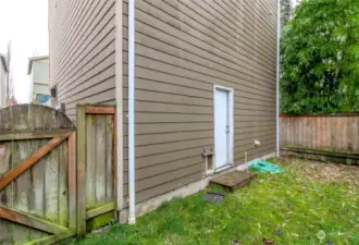 Fully fenced backyard with private door and gate.