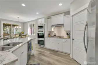 The kitchen shines with sparkling countertops and can lighting.
