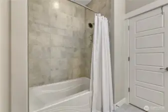 The tub/shower combo in the primary bath.