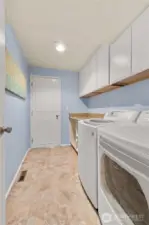 Utility room downstairs. Lots of room for folding and storage! 2-car garage is through that door.