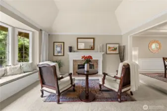 Living room off the entry with bay window, and storage in the bench.