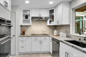 This seamless stainless steel sink and built-in microwave complete the fabulous kitchen remodel. The door on the left of this photo opens to a large pantry closet.