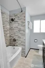 Remodeled in 2021, the hall bath boasts both tub and shower.