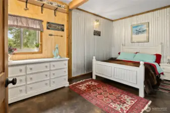 Spacious guest room with large closet! Stained concrete floors, cute metal accent walls.