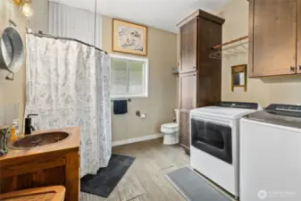 Main floor laundry & 3/4 bath. Fun sink! Washer & Dryer stay. We have instahot & a tankless hot water heater too for efficiency.