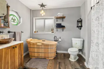Primary Suite is cowgirl chic with this incredibly unique wooden tub & separate shower.