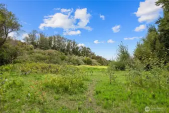 There is a man made creek that runs year round from the Yakima River. It feeds the historic Thorp Mill ponds! Beyond the creek is the Palouse to Cascades State Park Trail, so it's very private back there!