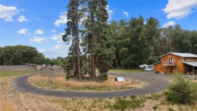 The circular driveway is fenced in the middle & makes a great spot for a dog run, chickens, or goats!