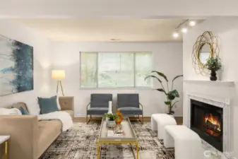 Large living room with abundance of light and wood burning fireplace