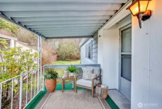 Covered porch, storm door at entry. Digitally staged.