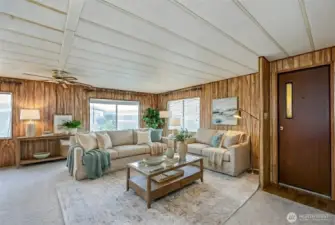 Entry and living room area. Digitally staged.