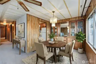 Dining area and built in shelving. Digitally staged.