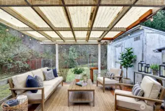 Covered back deck to enjoy year-round and watch the wildlife. Digitally staged.