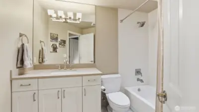 The full hall bath has also been updated with quartz counters, tile to the ceiling and tile flooring.