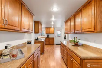 Hallway to kitchen with lots of great counterspace and storage.
