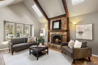 Just off of the front entrance, you'll find an inviting front living room with cozy wood fireplace. The bay window and skylights provide tons of natural light.