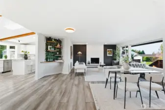 Large living and dining space filled with natural light. Custom automatic blinds stay with the home.