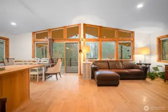 The spacious 'great room' has a wall of windows. To the left is the kitchen area and a large breakfast bar. New interior paint throughout the home too!
