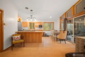 As you walk into your new home, you'll see the dining area and the fully equipped kitchen with custom cabinetry.