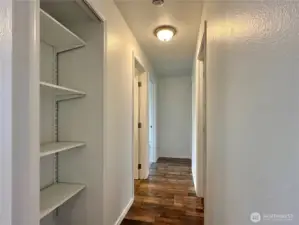 Hallway to 3 bedrooms and full bathroom