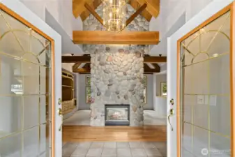 This impressive 2 story, dual sided river rock fireplace is the first thing you see!