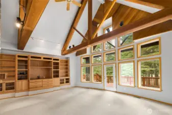 Sunken living room with gorgeous exposed beams, vaulted ceilings & a built-in entertainment center.
