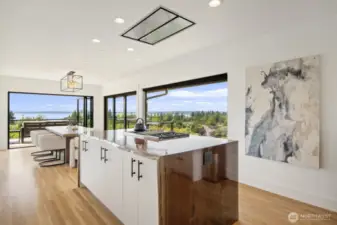 Live edge custom island with waterfall edges and flush mount vent hood for unobstructed views.