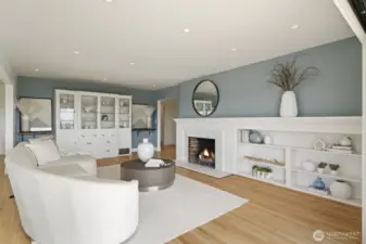 Living room with hardwood floors, wood burning fireplace and built in storage.