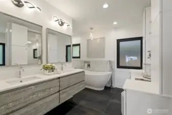 Primary ensuite with floating vanities, heated floors, free standing tub, walk-in closed and built in safe.