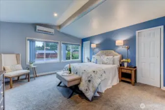 Primary bedroom with Primary Bath adjacent. Also a walk thru closet behind the bed area. lots of windows create plenty of natural light in this home