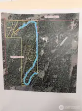 This shows the approximate location of the driveway. The house is at the upper left where the blue line stops.  The two pink dots are the approximate location of power vaults that could serve the property.