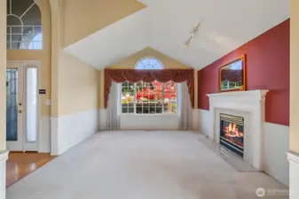 Vaulted living with gas fireplace. Custom wood mantal