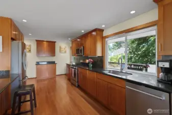 Huge kitchen - perfect size for farm living, right?! Stainless appliances, gas cooking, and 'acres' of granite-topped workspace.