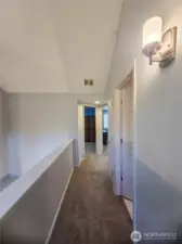 Upstairs hallway leads to all bedrooms, laundry room and full main bathroom.