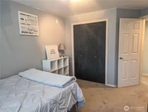Another view of bedroom #2 looking from the window to the hallway, with the door to the main full bathroom right next to the bedroom door in the hallway.