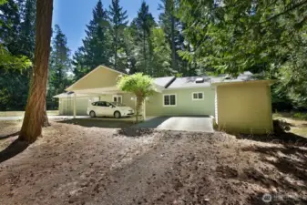 Carport in front of house for easy drop off and weather protection in addition to the oversize garage.