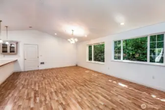 View of great room and dining area. Door leads to large two car garage.