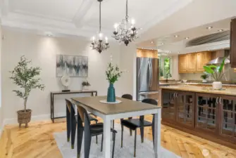 Dining room features two beautiful chandeliers, extra lighting, vaulted ceilings and plenty of room for a large table.
