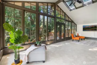 Solarium has ceramic tile floors, 4 skylights and two walls of windows.  Step out through the French doors to the secluded deck.