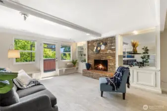 Beautiful bonus room on the lower level features a wood-burning fireplace and access to the hot tub!